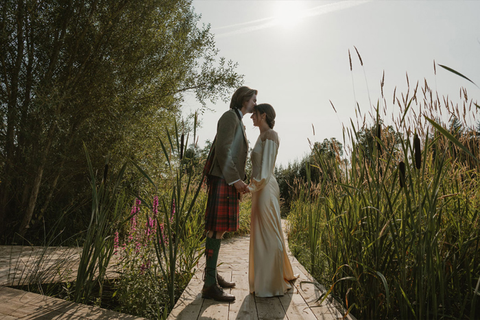 A Groom Kissing A Bride On The Forehead At Hartree Estates