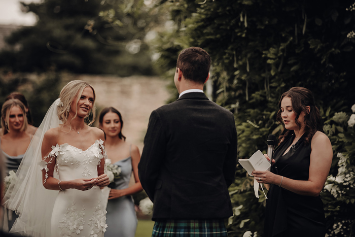 A Bride Looks At A Groom During Outdoor Wedding Ceremony