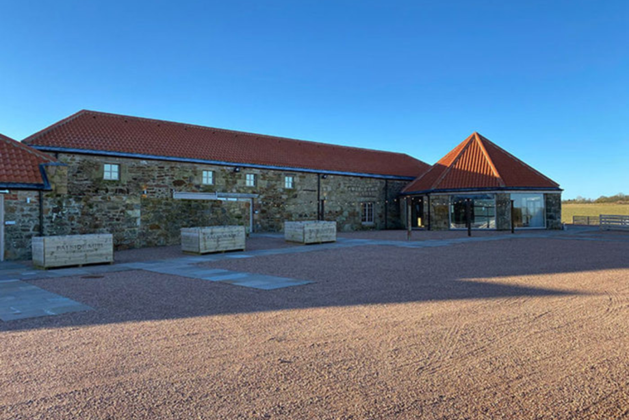 shot of barn next to blue sky