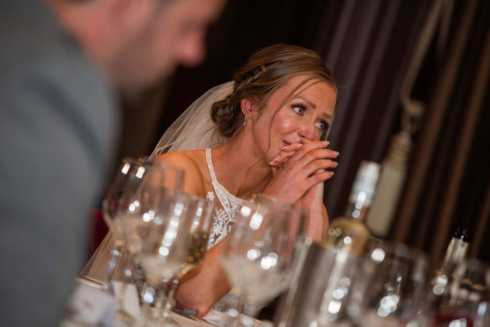 A Person Looking Emotional Sitting With Their Hands Clasped