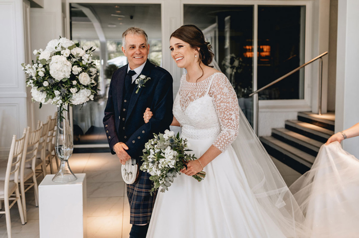 Bride and her father walk down the aisle