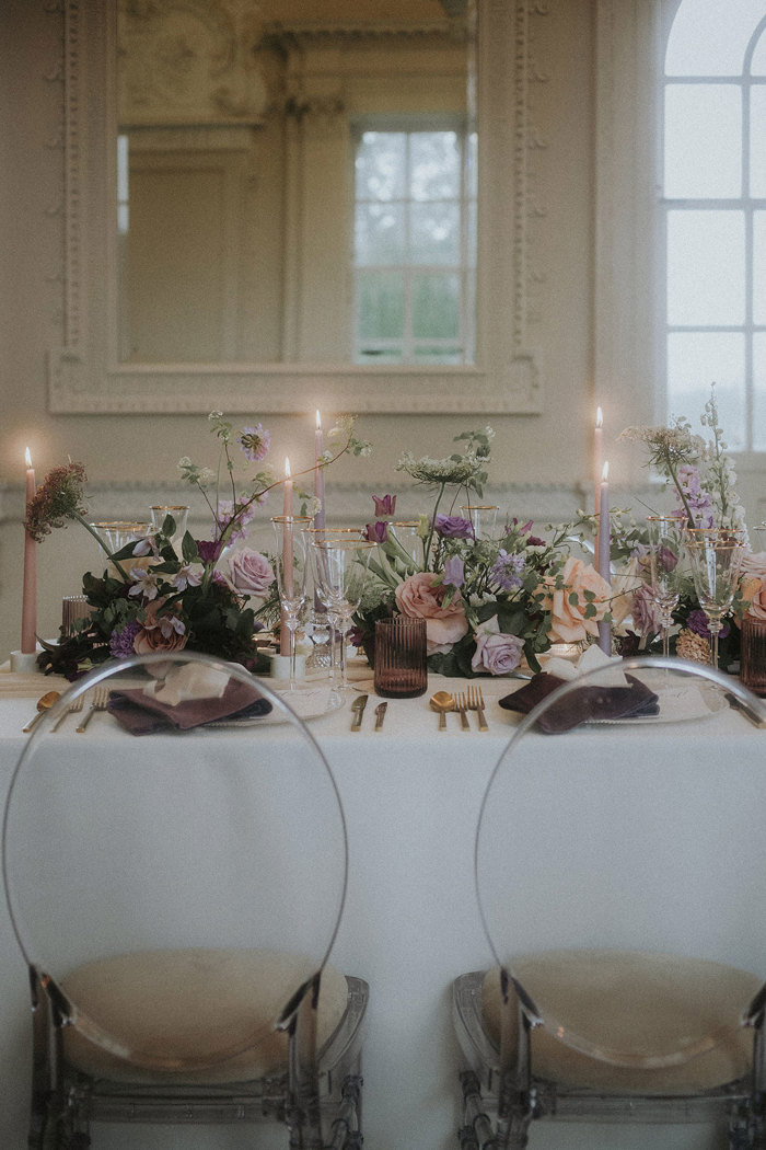 wedding floral arrangements on table with ghost style chairs Chatelherault styled shoot