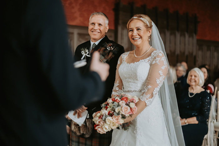 Bride and groom smile during the ceremony