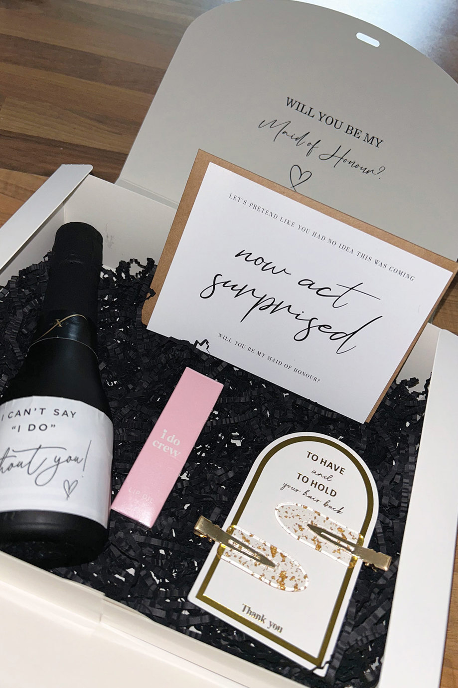 a close-up of a bridesmaid proposal box containing gifts