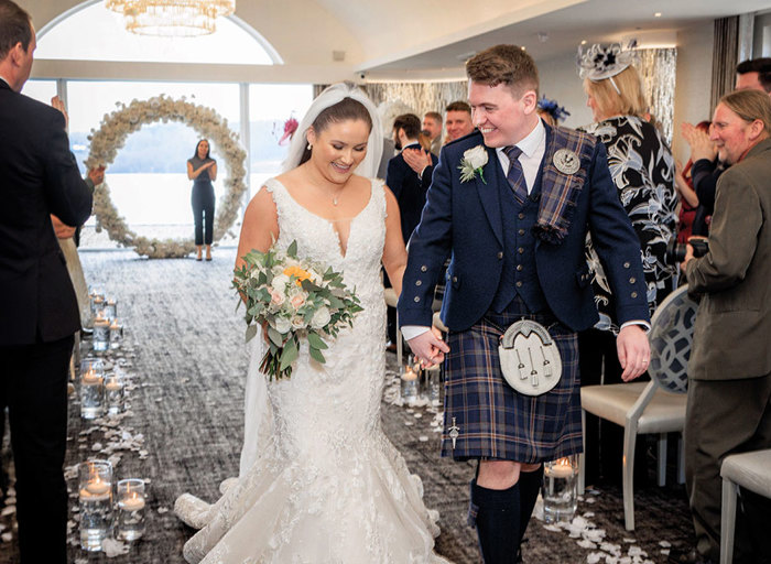 bride and groom walking down aisle after getting married