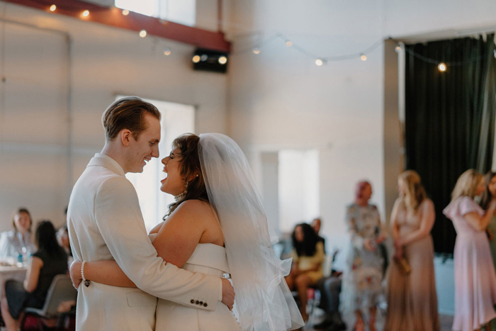 Bride and groom look excited during their first dance