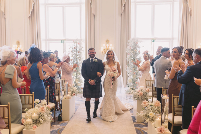 Bride and groom walk up the aisle