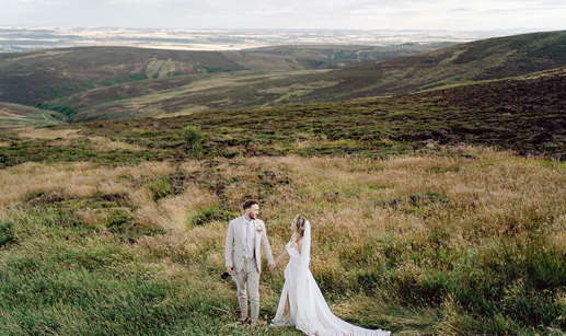 bride and groom on top of Cairn o'Mount on wedding day