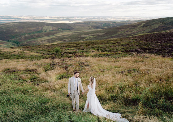 bride and groom on top of Cairn o'Mount on wedding day