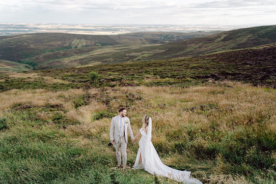bride and groom on top of Cairn o'Mount on wedding day