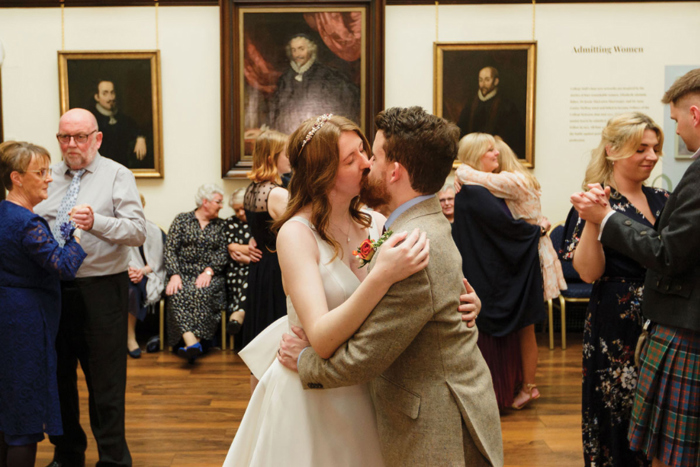 Bride and groom kiss at 1599 at the Royal College