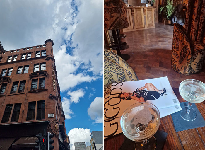 red sandstone building next to blue sky, with two couple glasses of prosecco on an oak table with editorial magazine behind