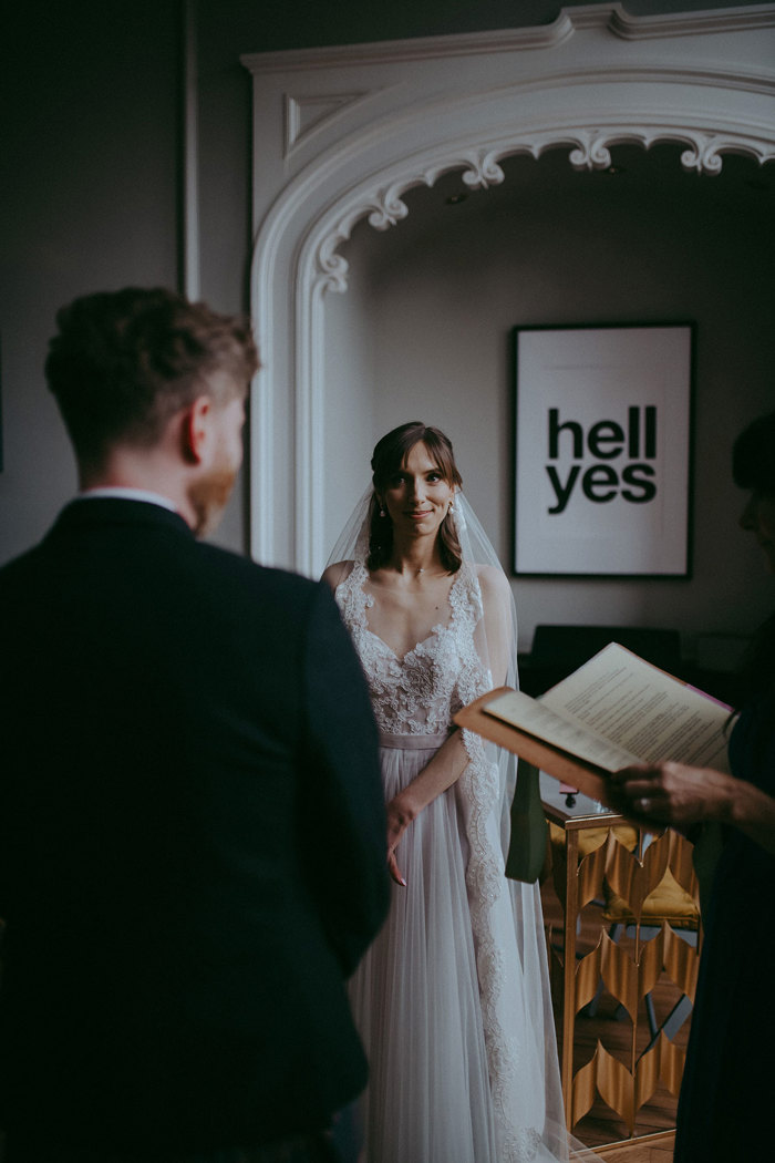 a bride looking at a groom during a wedding ceremony at Netherbyres House