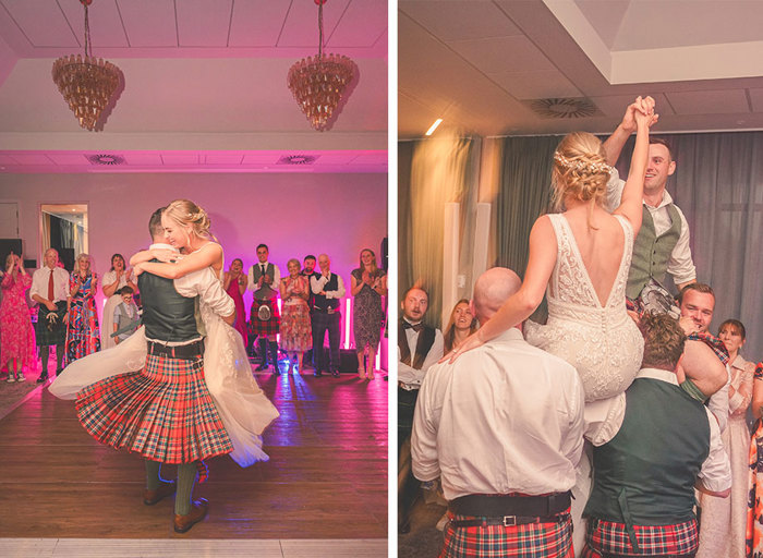 Bride and groom dancing and being lifted by the wedding party