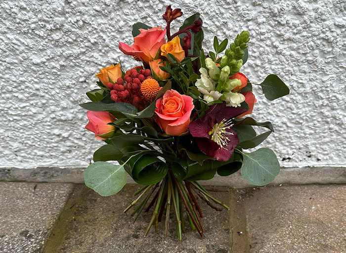 A bright bouquet with orange and purple flowers 