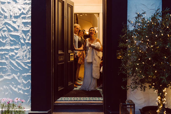 Bride stands in illuminated doorway