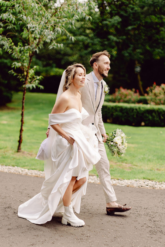 bride and groom walk through the grounds of drumtochty castle after getting married