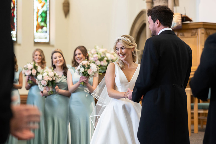 Bride and groom smile during the ceremony