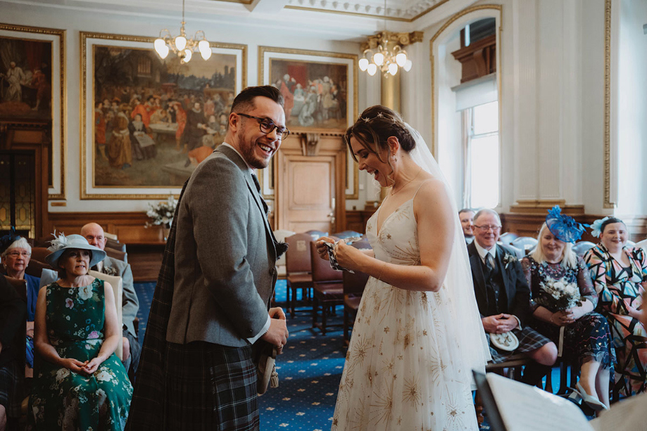 Bride and groom smile during the ceremony