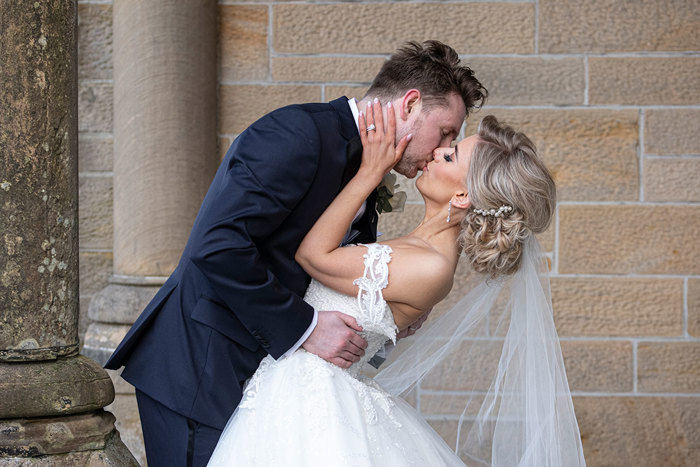 A Bride And Groom Kissing