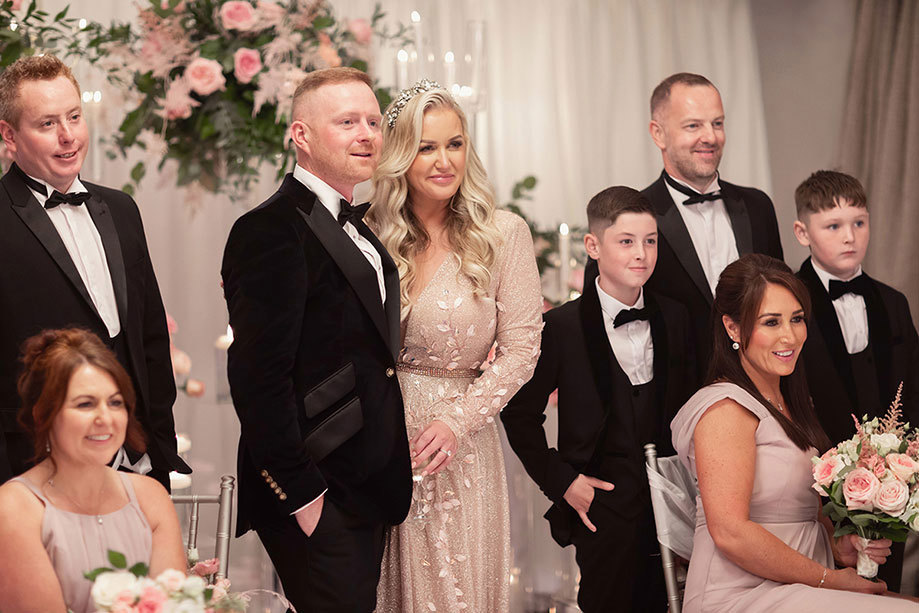 Group of people posing for a photo at a wedding at the Torrance Hotel 