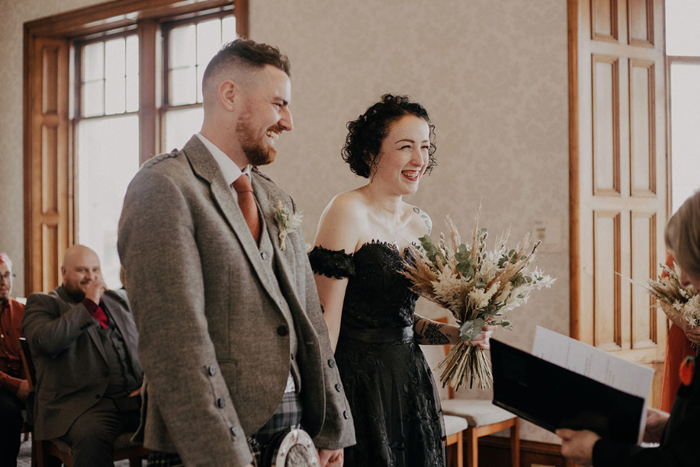 Bride and groom smile during the ceremony