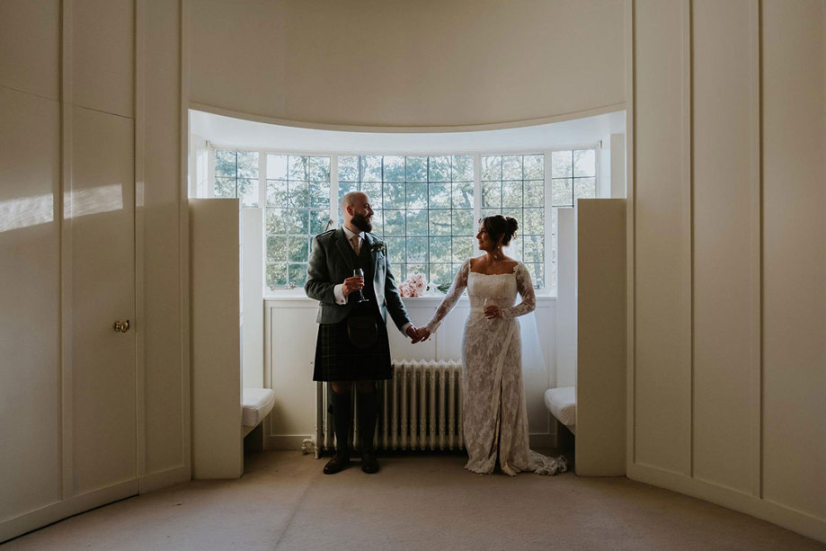 Couple hold hands inside House For an Art Lover