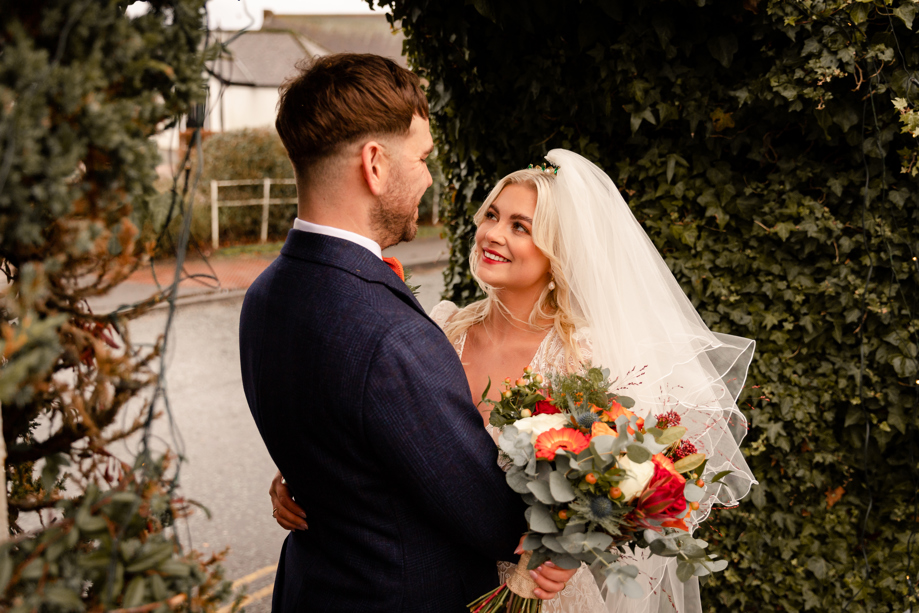 bride and groom smiling at one another at wedding at gretna green