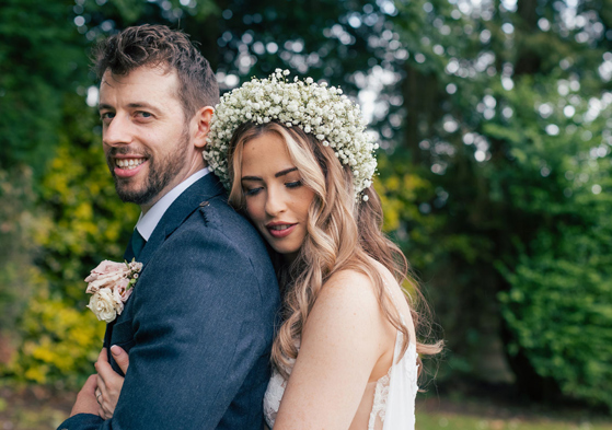 Bride cuddles into groom during couple portrait