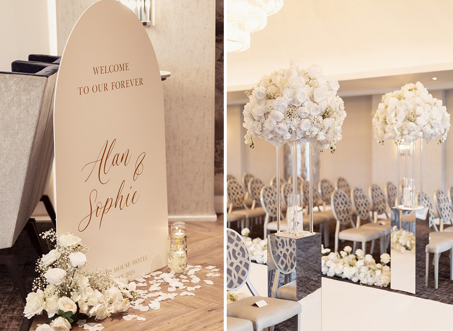 a wedding welcome sign with gold script font and small white flower arrangement and candles in jars on left. A room set for a wedding ceremony with plush oval backed chairs, white carpet aisle and tall white rose and gypsophila flower arrangements on mirrored plinths on right