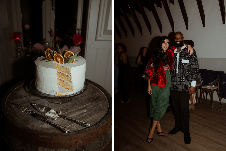 A White Wedding Cake With Dried Orange Decoration On Top And Two People Pose For A Photo At Dougarie Boathouse