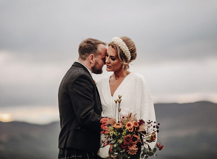 a groom kissing a bride on the cheek