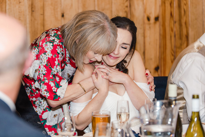 Bride is hugged by a guest