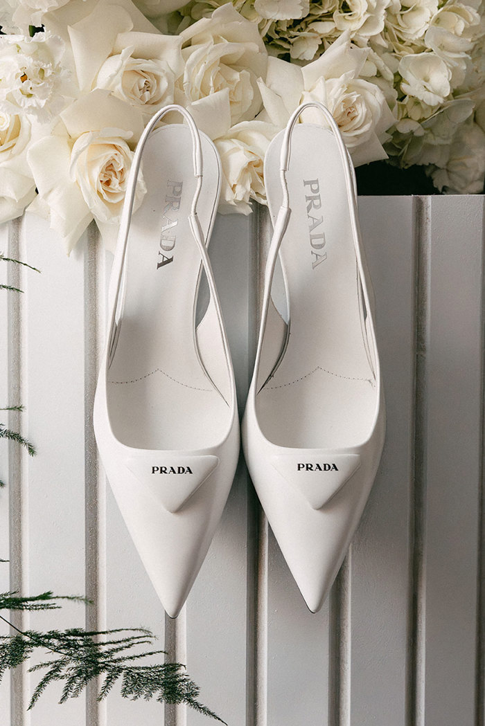 a white slingback style of pointed toe Prada heels