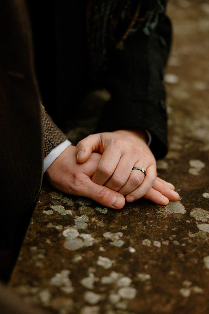 hands on a stone wall