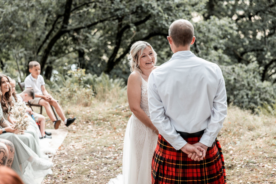 Bride faces groom during ceremony and smiles