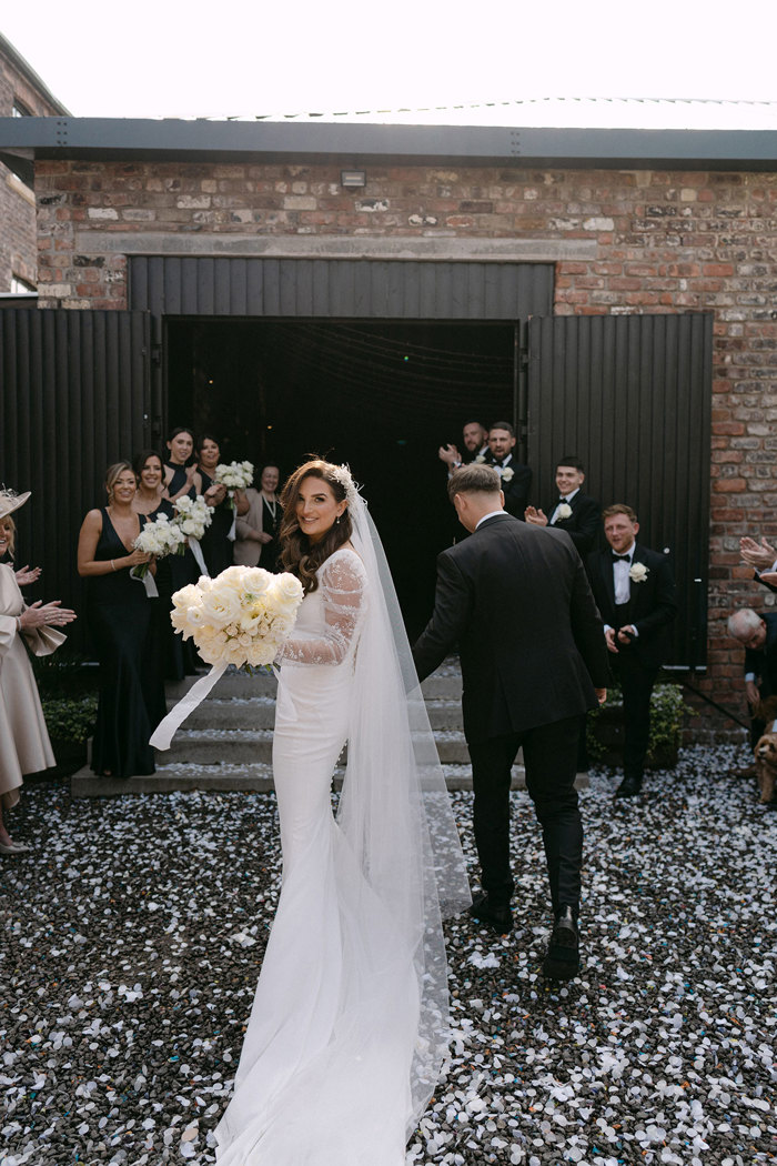 a bride and groom outside the Engine Works after a confetti shower