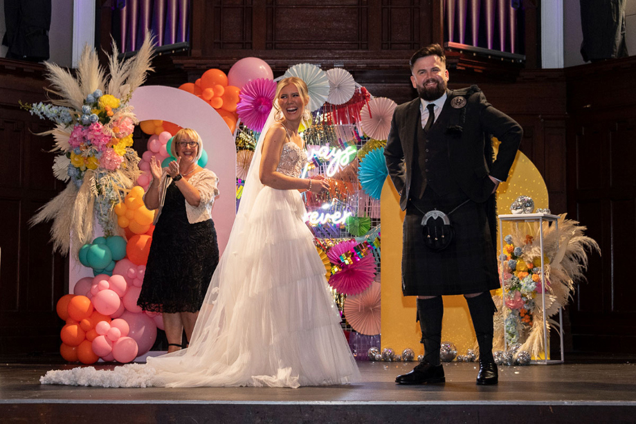 Bride and groom laugh during their wedding ceremony at St Luke's Glasgow