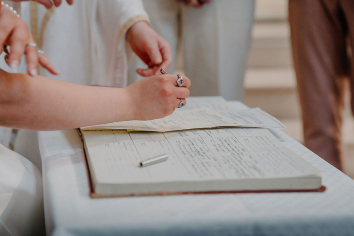 Couple's hands signing documentation