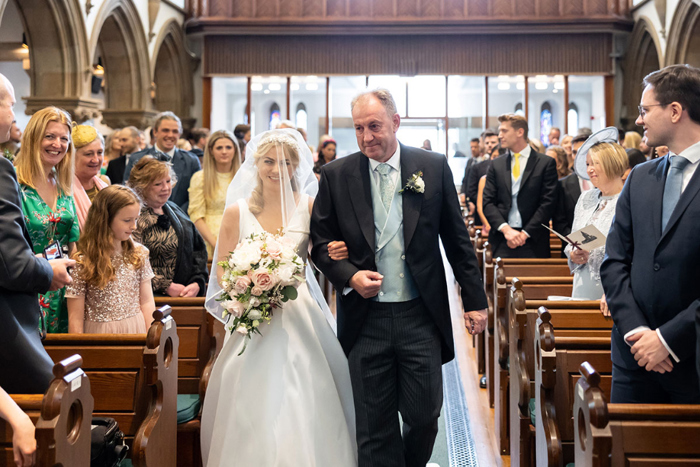 Bride and her father walk down the aisle