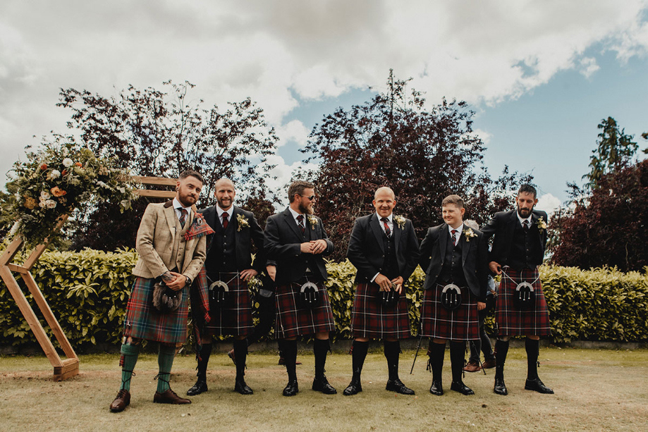 Groom and groomsmen wait on the ceremony to start