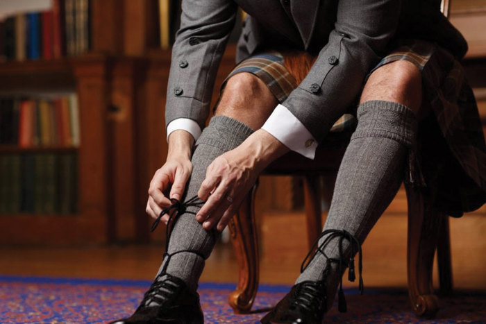 a man tying his black ghillie brogues