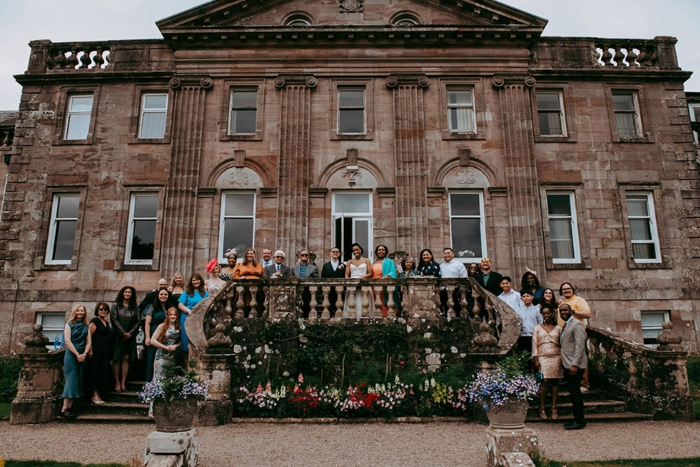 Group shot of wedding party outside venue