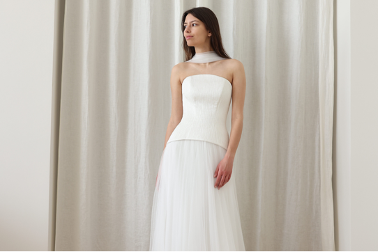 woman in white dress with fitted bodice and tulle skirt