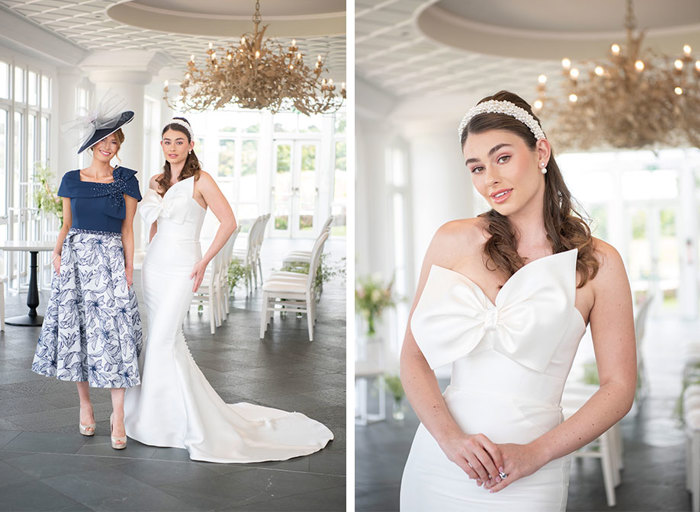 A woman in a navy and white dress and a blue hat standing next to a woman in a floor-length wedding dress with a large bow on the front