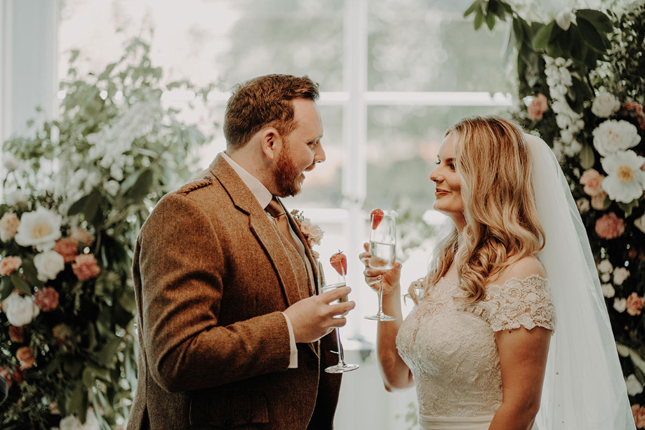 Bride and groom cheers their drinks