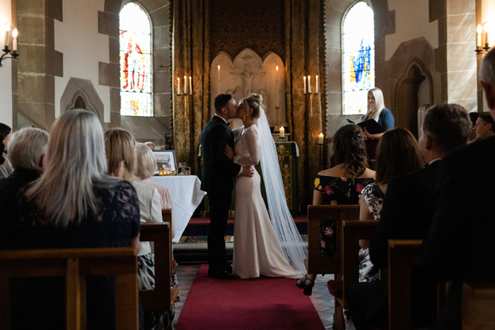 Bride and groom kiss at the end of their ceremony