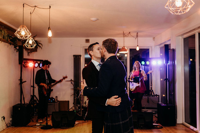 Grooms kiss on the dancefloor