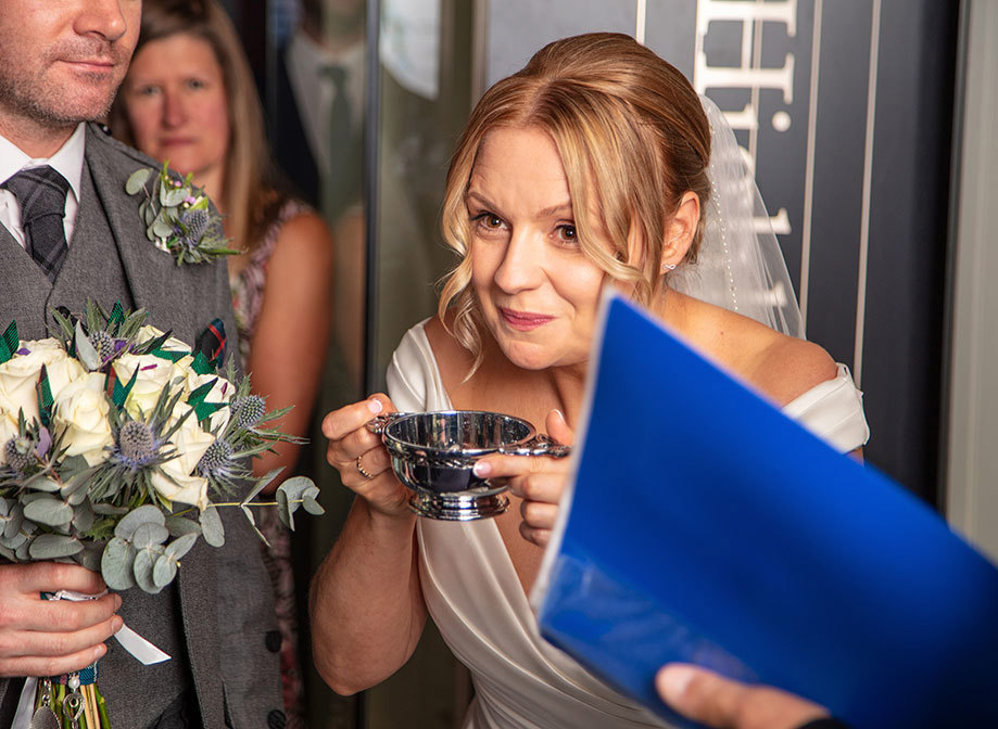 A bride drinking from a quaich