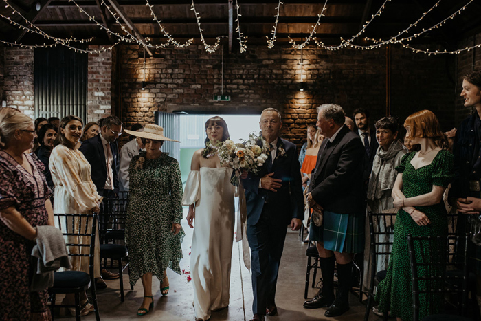 Bride being walked down the aisle by her father